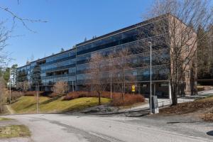 an office building with a road in front of it at 3-bedroom lake view and near center apartment with sauna in Lahti