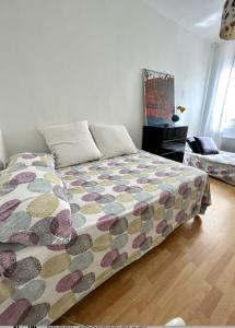 a bedroom with a bed with a colorful comforter at Appartement centre ville avec Patio in Marseille