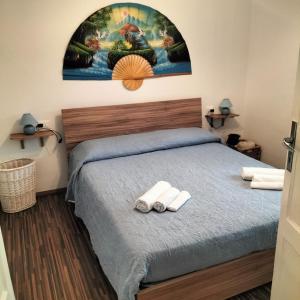 a bedroom with a bed with two towels at Casa Matilde in Genova +36 photos
