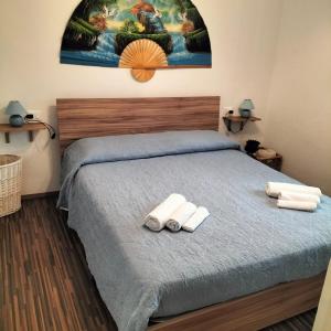 a bedroom with a bed with two towels on it at Casa Matilde in Genoa
