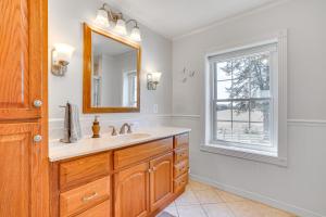 a bathroom with a sink and a mirror and a window at Historic Jefferson Farmhouse - Hike, Bike and Raft! in Jefferson +33 photos
