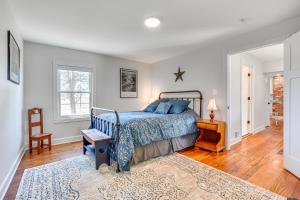 a bedroom with a bed with a blue bedspread at Historic Jefferson Farmhouse - Hike, Bike and Raft! in Jefferson