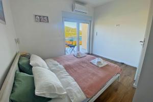 Postel nebo postele na pokoji v ubytování Apartmani Portina