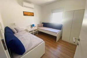 Postel nebo postele na pokoji v ubytování Apartmani Portina