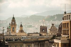 a city skyline with buildings and a clock tower at Casa Matilde in Genoa