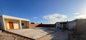 a house is being built with a brick wall at Espaço Analu in Aracati