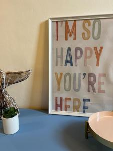a sign that says i miss happy youre here on a table at Casa Ondea in Marina di Pisa