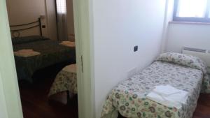 Postel nebo postele na pokoji v ubytování LeonessAffittacamere