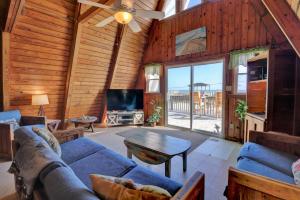 a living room with a blue couch and a tv at Copper Top in West Onslow Beach