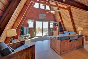 a living room with couches and a ceiling fan at Copper Top in West Onslow Beach +19 photos