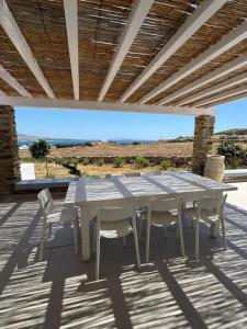 a white table and chairs on a patio at Chic flat with terrace in Antiparos and sea view in Andiparos