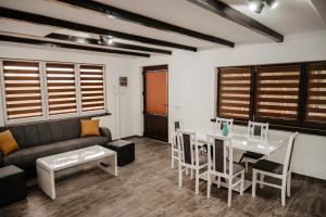 a living room with a couch and a table at Cabana Petersdorf in Petreşti +21 photos