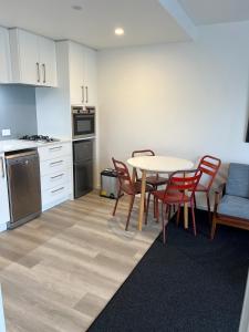 拉塞尔Russell Apartment - Unit 1的配有桌椅的厨房和餐厅