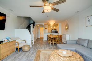 a living room with a couch and a table at Villa Capriani 317A in North Topsail Beach