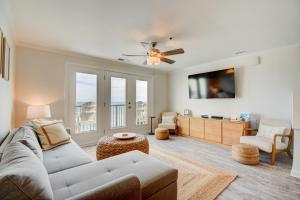 a living room with a couch and a tv at Villa Capriani 317A in North Topsail Beach
