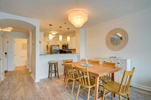 a dining room and kitchen with a wooden table and chairs at Villa Capriani 317A in North Topsail Beach