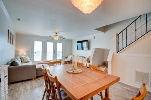a dining room and living room with a table and chairs at Villa Capriani 317A in North Topsail Beach +27 photos
