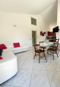 a living room with a white couch and a table at Sole&Luna in Armungia +19 photos
