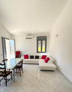 a living room with a couch and a table at Sole&Luna in Armungia