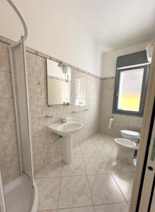 a bathroom with a sink and a toilet at Sole&Luna in Armungia