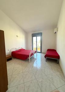 a bedroom with a red bed and two benches at Sole&Luna in Armungia