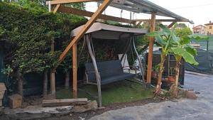 a gazebo with a bench in a garden at Apartamento Premium Relax D in Cicero
