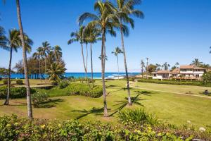 a view of the beach and palm trees at Manualoha 901 Minutes to Poipu in Koloa