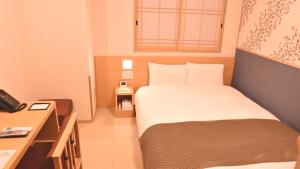 a small room with a bed and a desk at Onyado Nono Asakusa Natural Hot Spring in Tokyo