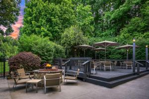 a patio with tables and chairs and umbrellas at Sonesta Charlotte Lower South End in Charlotte +62 photos