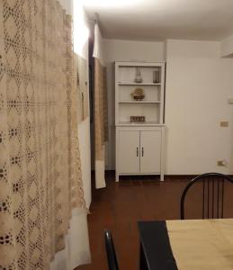 a dining room with a table and a curtain at I Mattoni Rossi in Imperia +23 photos