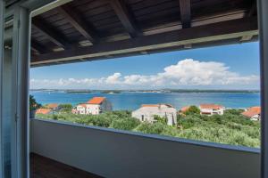 a view of the water from the balcony of a house at Apartment in Tkon - Insel Pasman 50975 in Tkon