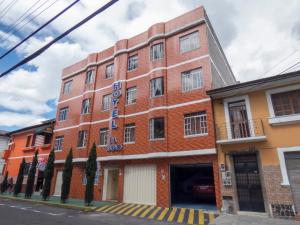a red brick building on the corner of a street at Hotel El Ejido in Quito