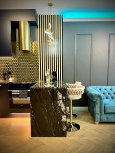 a kitchen with a table and a blue couch at Golden Park Aparthotel in Szczecin +81 photos