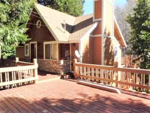 a house with a brick porch and a wooden fence at Potomac 2 - v066 Cabin in Lake Arrowhead