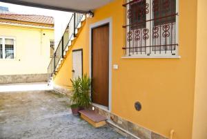 a yellow building with a door and a balcony at B&B I Girasoli in Francavilla al Mare