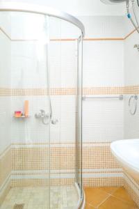 a bathroom with a shower and a sink at Twin Villa Tragjas in Vlorë +18 photos