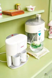 a coffee maker and cups on a shelf at Twin Villa Tragjas in Vlorë