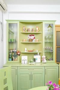 a green hutch with items on it in a room at Twin Villa Tragjas in Vlorë