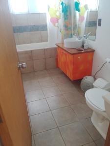 a bathroom with a sink and a toilet at casa Wamani in Santiago