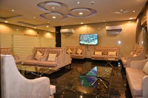 a waiting room with couches and a flat screen tv at شقق المكان الراقي للشقق المخدمة in Riyadh