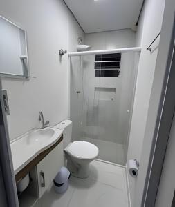 biała łazienka z toaletą i prysznicem w obiekcie Ap Elegante e pratico com ar, ao lado do Aeroporto w mieście Guarulhos