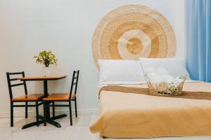 a bedroom with a bed and a side table at Tahan Hostel in Puerto Princesa City