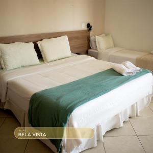 two beds sitting next to each other in a room at Bela Vista Hotel in Arujá +19 photos