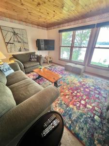 a living room with a couch and a table at SEBAGO ESCAPE LIMIT 12 home in Raymond