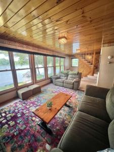 a living room with a couch and a table at SEBAGO ESCAPE LIMIT 12 home in Raymond +22 photos