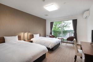 Postel nebo postele na pokoji v ubytování 里沼リゾート　Hotel KOMORINU