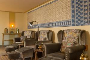 a waiting room with chairs and a painting on the wall at Amnaya Resort Kuta in Kuta