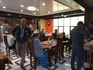 a group of people sitting at tables in a restaurant at Hotel Salty House in Uyuni +13 photos