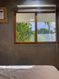 a window in a room with a bed and a view at SUMMER HOUSE B Starlink in General Luna