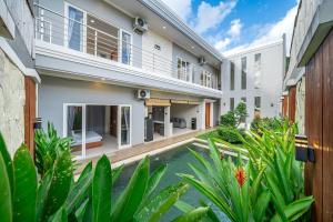 an exterior view of a house with a swimming pool at Modern 3BDR Villa - Between Seminyak & Canggu in Kerobokan +12 photos